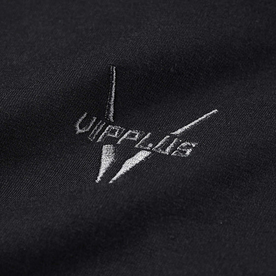 Close-up of black fabric featuring the embroidered Vippläts logo, showcasing quality detail and craftsmanship.