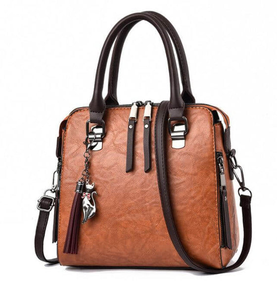 Ladies luxury crossbody handbag with soft surface, zipper opening, spacious design, and adjustable strap.