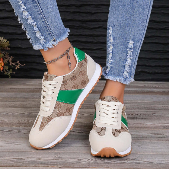 Contrast round-toe flat sneakers in beige and green, paired with distressed jeans and a casual look, perfect for stylish comfort.