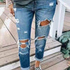 Low waist jeans with distressed details in blue denim fabric.