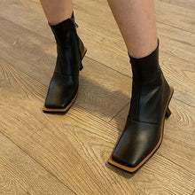  Fashion leather high-heeled Martin boots with side zipper and metal elements.