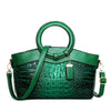 Luxury handbag for moms in green crocodile print design with large size and round handles.