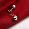 Creative 6M 8M 10M Bead Stud Earrings with silver-plated copper and bold geometric design on red fabric surface.