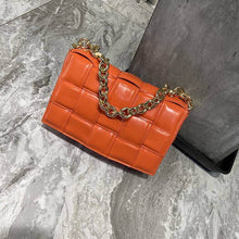  Woven Small Cowhide Square Chain Handbag in orange on marble background.