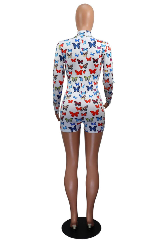 V-neck printed sheath skirt long sleeve jumpsuit with butterfly design in white.