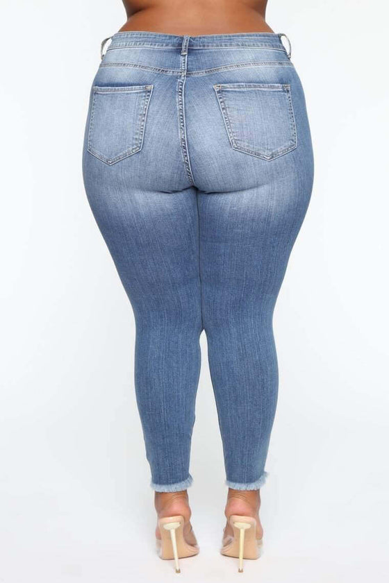 Plus size high waist stretch ripped women jeans in blue.