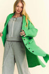 Davi & Dani side slit button up hooded cardigan in green over a casual grey outfit.