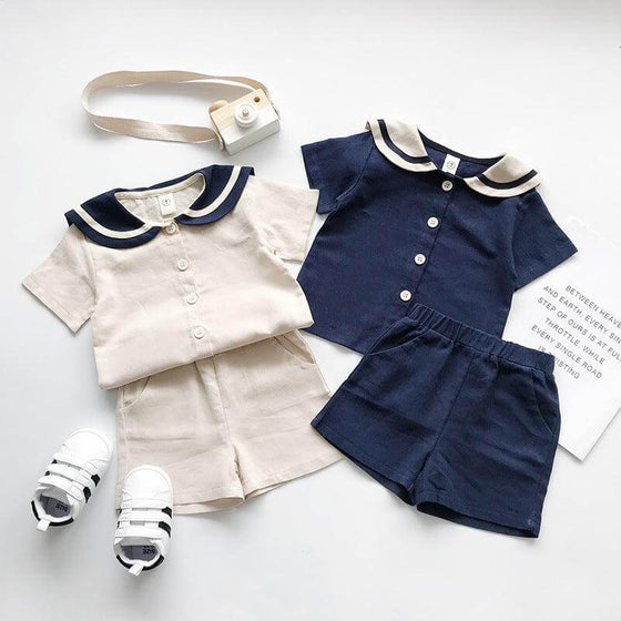 Boys and girls Navy solid short sleeves setsGear up for summer with our boys and girls Navy solid short-sleeved sets! Made with 90% cotton, these two-piece pants suits are perfect for both boys and girls. Say Infant setsPlush Fashions ShopPlush Fashion Shopgirls Navy solid short sleeves sets