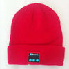 Red wireless knitted headset hat with Bluetooth controls, offering music and connectivity.