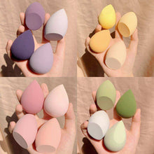  Colorful synthetic makeup egg sponges held in hand, ideal for flawless application.