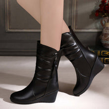  Women's black snow boots with plush lining, side zipper, and wedge heel for style and comfort.