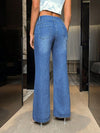 Woman wearing bootcut jeans with pockets, showcasing a stylish fit and comfortable design in a chic setting.