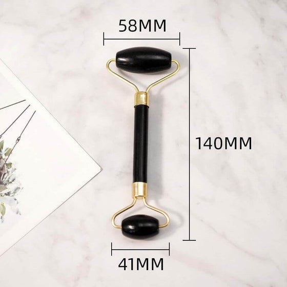 Beauty Face Care Massage Jade Device with black Bianstone rollers and gold handles, dimensions 58mm x 41mm x 140mm.