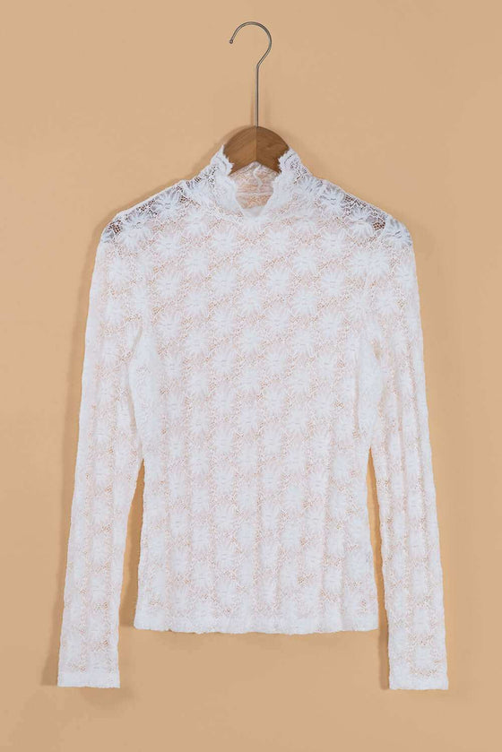 Mock neck long sleeve lace top in white, semi-sheer design, on hanger.