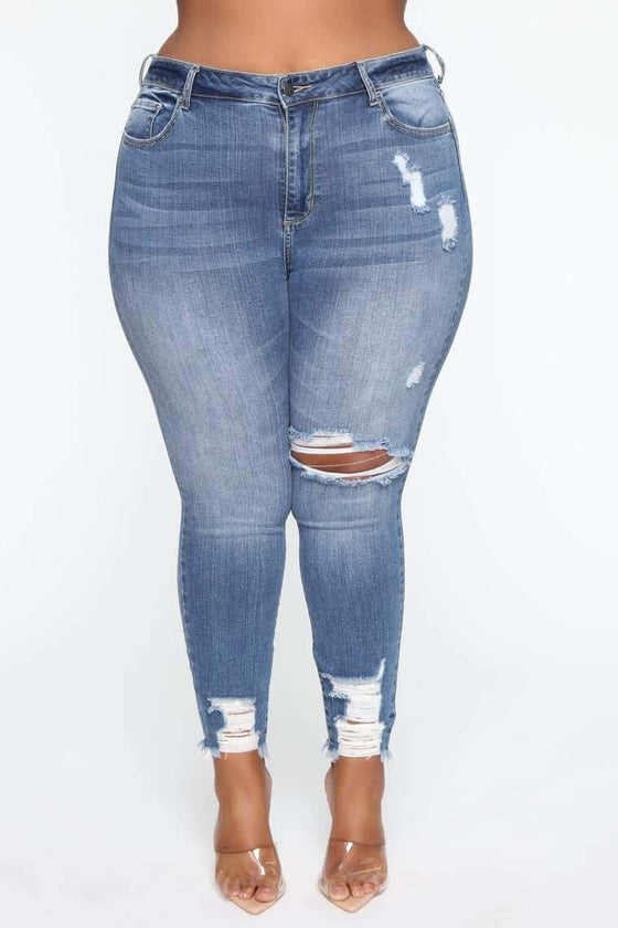 Plus size stretch ripped jeans for women in blue denim.