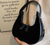 Fashion high-grade matte French minority handbag for women with single shoulder strap and soft handle in black.