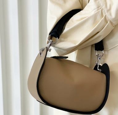 Female high-end retro diagonal handbag in milk tea brown displayed on a person's shoulder.