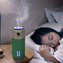  Adjustable Spray Size USB Mini Office Car Humidifier next to a sleeping person.