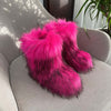 Women's pink fluffy plush snow boots with dark accents, perfect for cozy winter wear.