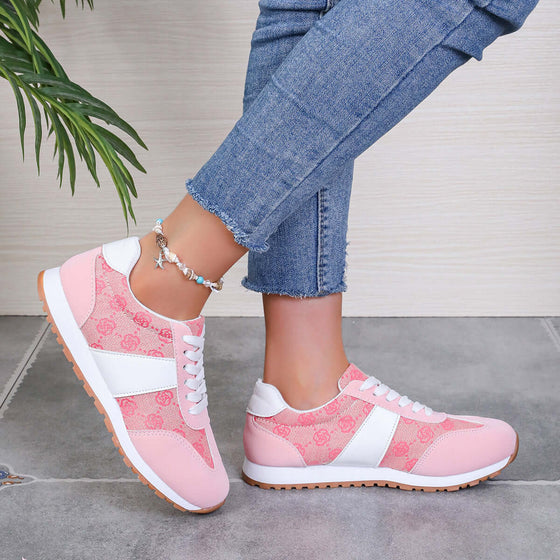 Stylish pink contrast round-toe flat sneakers showcased with denim jeans on a tiled floor, perfect for comfortable fashion.