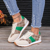 Contrast round-toe flat sneakers in beige and green, perfect for stylish comfort, paired with trendy distressed jeans.