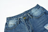 Blue low waist jeans with distressed details and front button closure.