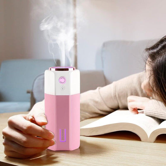 Adjustable Spray Size USB Mini Office Car Humidifier in pink, ideal for personal use and portable comfort.