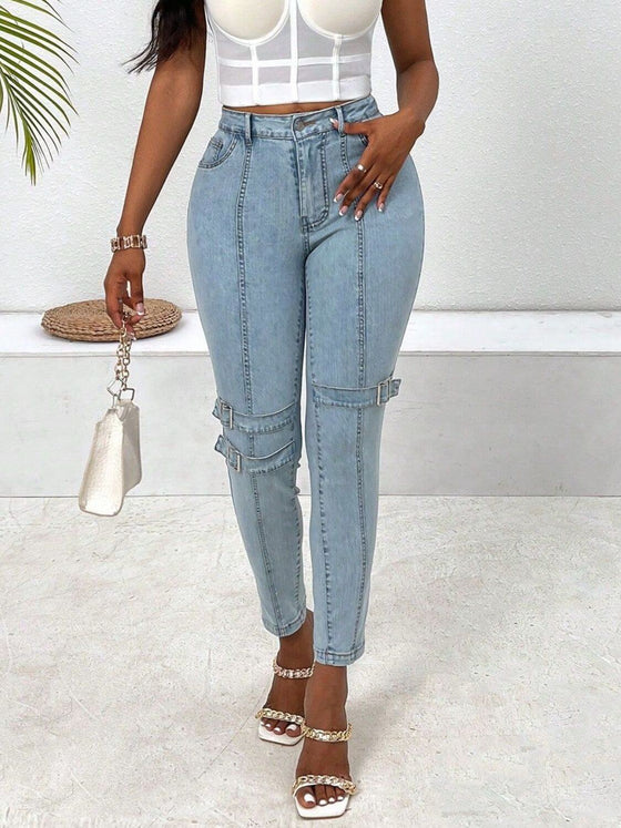 Woman wearing Decorative Buckle Skinny Jeans with pockets, styled with a crop top and trendy sandals.