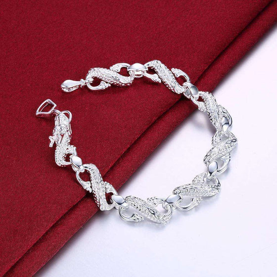 Unisex white dragon bracelet with intricate silver detailing.