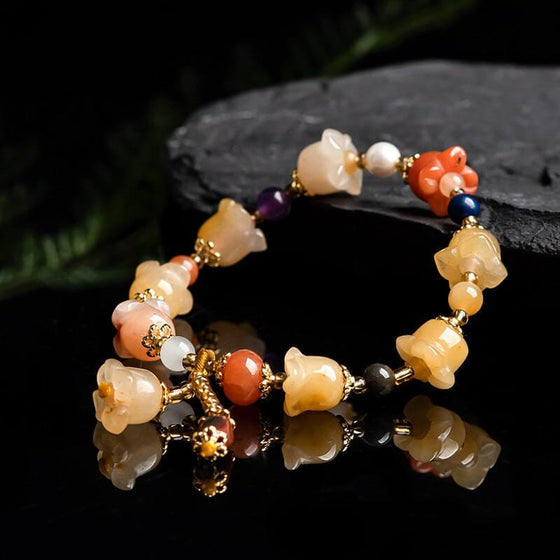 Natural Xinjiang Gold Silk Magnolia Bracelet with Jinsi Jade and orchid beads.