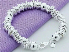  New Arrival 925 Silver Color Charm Cuff Bangle for Women on purple fabric.