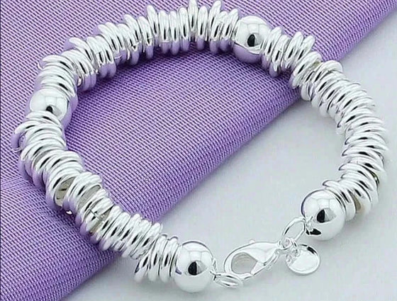 New Arrival 925 Silver Color Charm Cuff Bangle for Women on purple fabric.