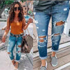 Trendy low waist jeans with distressed details and a stylish look.