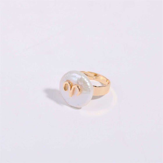 Cosmic Constellation Ring with gold details on a white surface.