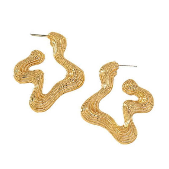 Retro style exaggerated female earrings in gold with geometric design.