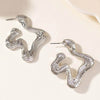 Retro style exaggerated female earrings with geometric design in silver.