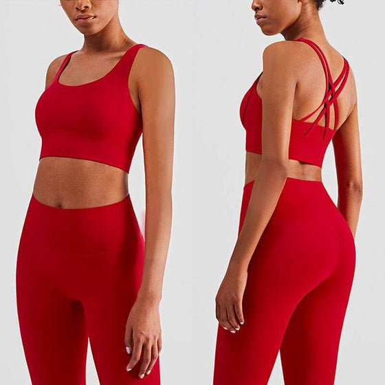 Red plush sports accessories two-piece yoga suit with cross-backless bra and cropped pants.