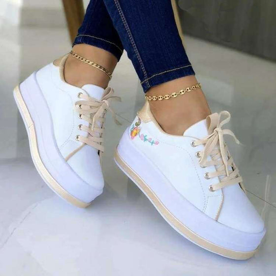 Women's platform sneakers with floral embroidery design, comfortable and stylish, suitable for everyday wear.