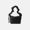 PU leather drawstring shoulder bag in black with ruched strap.