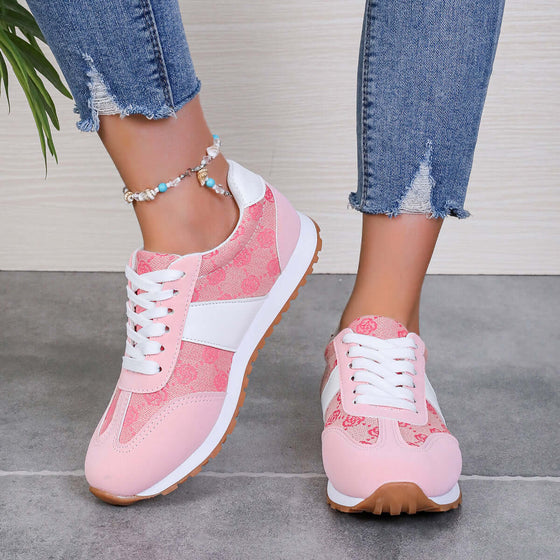 Contrast round toe flat sneakers in pink with white accents, showcasing stylish design and comfortable fit.