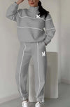 Women's gray pullover sweatsuit set with stylish stripes and pockets, perfect for casual lounge wear.