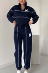 Women's navy pullover sweatsuit set with stylish stripes and pockets, perfect for casual lounge wear.