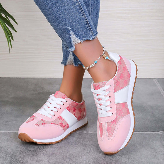 Contrast round toe flat sneakers in pink and white, styled with ripped jeans for a trendy look.