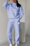 Women's blue hoodless pullover sweatsuit set with stylish stripes and logo, perfect for cozy casual wear.