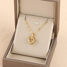  Heart-shaped gold chain necklace with double-layer pendant in titanium steel, displayed in a jewelry box.