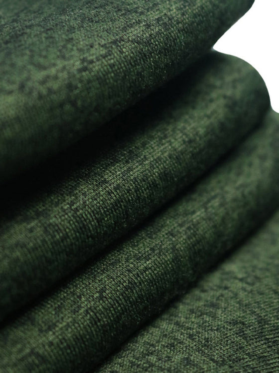 Close-up of green cationic knit fabric used for men's sports trousers.