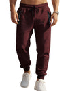 Men's maroon slim fit sports trousers with zipper cuffs and slant pockets, made from cationic polyester fabric.