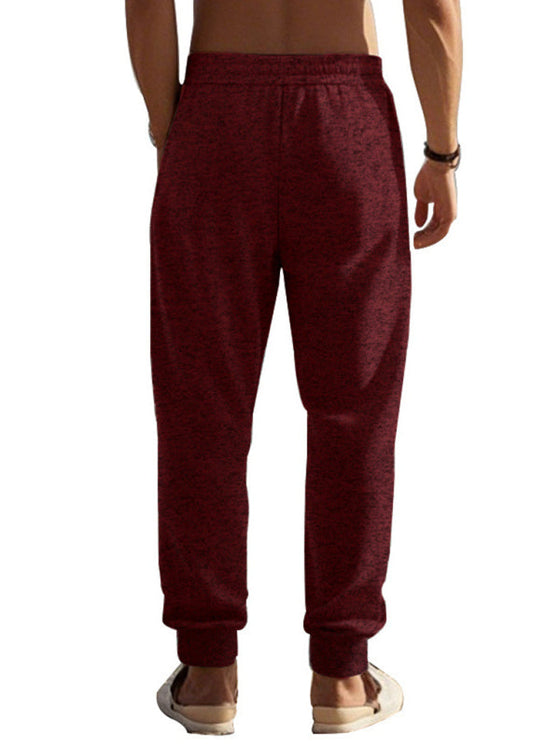 Men's casual cationic slim fit sweatpants with zipper cuffs and self-design pattern.